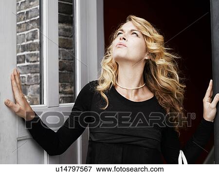 Woman standing outside door View Large Photo Image Stock Photo - Woman standing outside door. Fotosearch