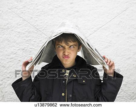 Boy (6-8) covering head with newspaper, pulling face View Large Photo Image Stock Image - Boy (6-8) covering head with newspaper, pulling face. Fotosearch