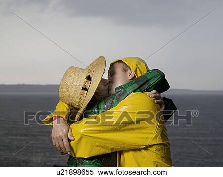 Couple kissing and hugging in the rain View Large Photo Image Stock Photography - Couple kissing and hugging in the rain. Fotosearch