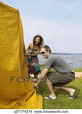 Man and woman putting up a tent View Large Photo Image Picture - Man and woman putting up a tent. Fotosearch