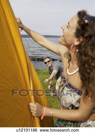 Man and woman putting up a tent View Large Photo Image Stock Photograph - Man and woman putting up a tent. Fotosearch