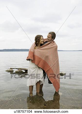 Man and woman standing in shallow water View Large Photo Image Picture - Man and woman standing in shallow water. Fotosearch