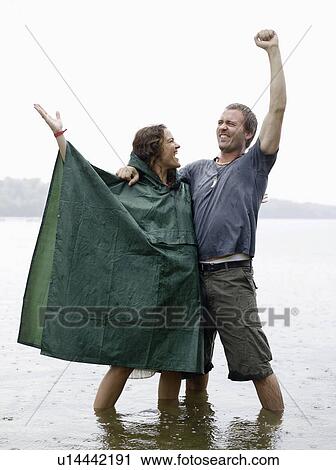 Man and woman standing in shallow water View Large Photo Image Stock Image - Man and woman standing in shallow water. Fotosearch
