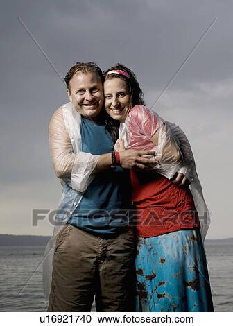 Man and woman standing in the rain View Large Photo Image Stock Image - Man and woman standing in the rain. Fotosearch