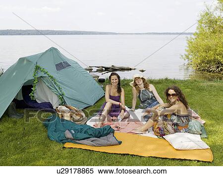 Three women camping by the water View Large Photo Image Stock Photography - Three women camping by the water. Fotosearch