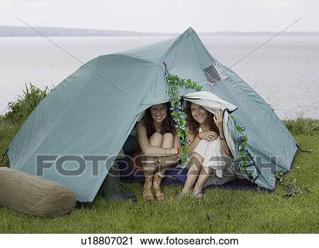 Two women looking out from tent View Large Photo Image Stock Image - Two women looking out from tent . Fotosearch
