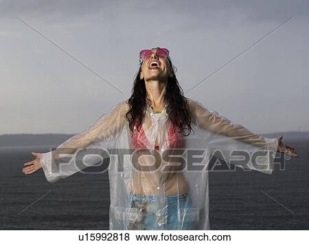 Stock Photo - Woman standing in the rain. Fotosearch
