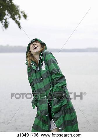 Woman with raincoat on in the rain View Large Photo Image Stock Photograph - Woman with raincoat on in the rain. Fotosearch