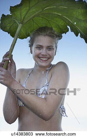 Young Woman sheltering from rain. View Large Photo Image Stock Image - Young Woman sheltering from rain.. Fotosearch