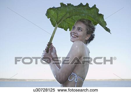Young Woman sheltering from rain. View Large Photo Image Stock Photography - Young Woman sheltering from rain.. Fotosearch