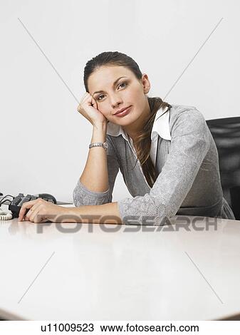 Stock Image - Businesswoman at her desk. Fotosearch