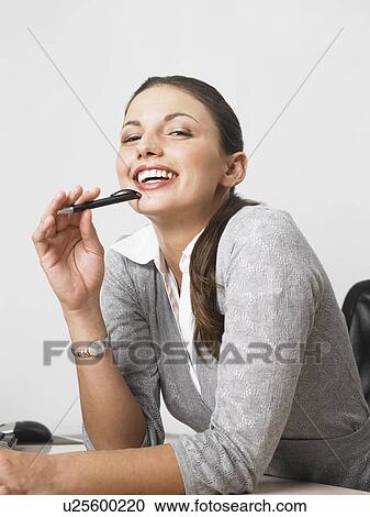 Stock Image - Businesswoman at her desk. Fotosearch