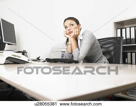 Stock Image - Businesswoman at her desk. Fotosearch