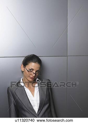 Businesswoman in front of a white wall View Large Photo Image Stock Image - Businesswoman in front of a white wall. Fotosearch