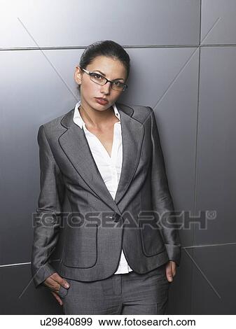 Stock Photo - Businesswoman in front of a white wall. Fotosearch