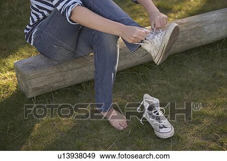 Young putting on training shoes. View Large Photo Image Stock Photo - Young putting on training shoes.. Fotosearch