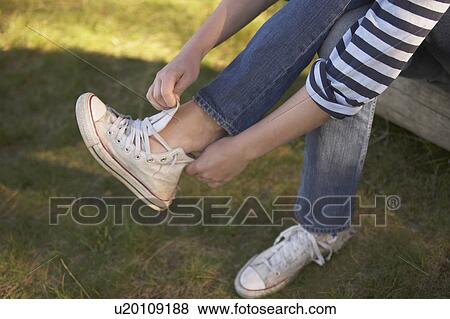 Young putting on training shoes. View Large Photo Image Stock Photo - Young putting on training shoes.. Fotosearch