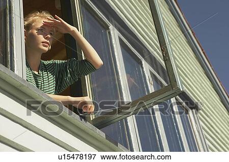 Young woman appearing from window. View Large Photo Image Stock Photo - Young woman appearing from window.. Fotosearch