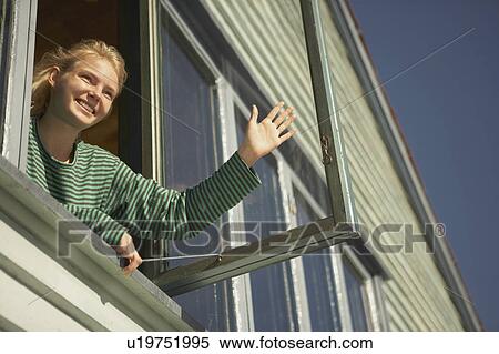 Stock Photography - Young woman appearing from window.. Fotosearch