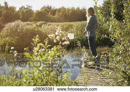 Young Woman by pond with fishing net. View Large Photo Image Stock Image - Young Woman by pond with fishing net.. Fotosearch
