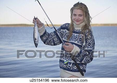 Stock Photograph - Young Woman having caught fish.. Fotosearch