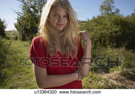 Young woman in nature wearing red dress. View Large Photo Image Stock Image - Young woman in nature wearing red dress.. Fotosearch