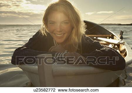 Young woman in rowing boat. View Large Photo Image Stock Image - Young woman in rowing boat.. Fotosearch