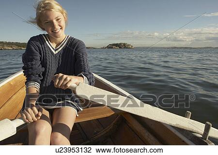 Young woman in rowing boat. View Large Photo Image Stock Image - Young woman in rowing boat.. Fotosearch