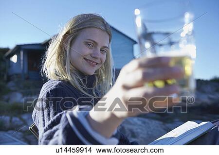 Young Woman relaxing on jetty. View Large Photo Image Picture - Young Woman relaxing on jetty.. Fotosearch