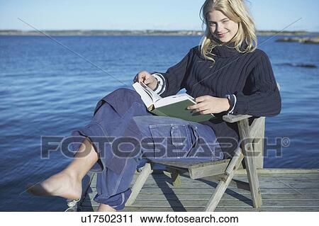 Young Woman relaxing on jetty. View Large Photo Image Stock Image - Young Woman relaxing on jetty.. Fotosearch