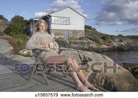 Young Woman relaxing on jetty. View Large Photo Image Stock Photo - Young Woman relaxing on jetty.. Fotosearch