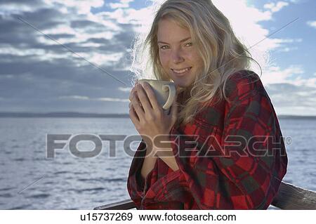 Young Woman relaxing on jetty. View Large Photo Image Stock Photo - Young Woman relaxing on jetty.. Fotosearch
