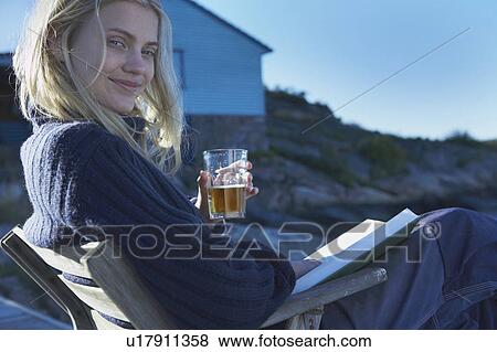 Young Woman relaxing on jetty. View Large Photo Image Stock Photo - Young Woman relaxing on jetty.. Fotosearch