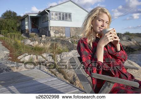 Young Woman relaxing on jetty. View Large Photo Image Stock Photo - Young Woman relaxing on jetty.. Fotosearch