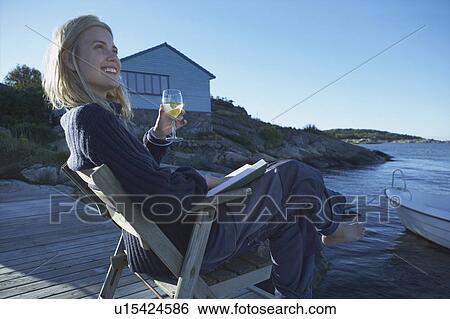 Young Woman relaxing on jetty. View Large Photo Image Stock Photograph - Young Woman relaxing on jetty.. Fotosearch