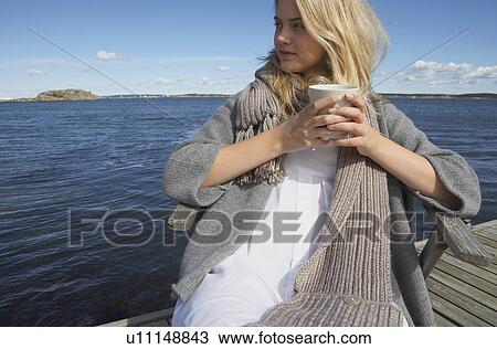 Stock Image - Young Woman drinking Coffee or Tea.. Fotosearch