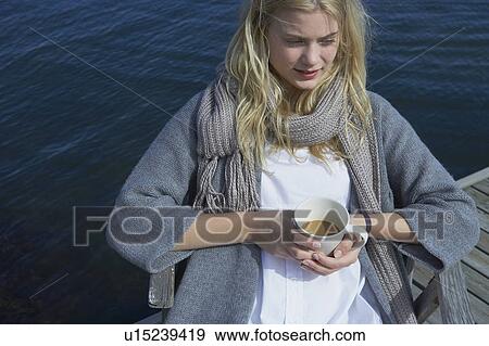 Stock Photo - Young Woman drinking Coffee or Tea.. Fotosearch