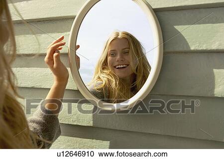 Young Woman Looking in Mirror outside. View Large Photo Image Stock Image - Young Woman Looking in Mirror outside.. Fotosearch