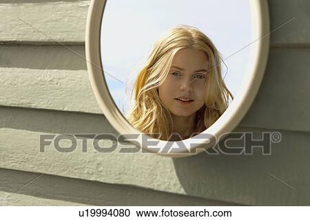 Young Woman Looking in Mirror outside. View Large Photo Image Stock Image - Young Woman Looking in Mirror outside.. Fotosearch
