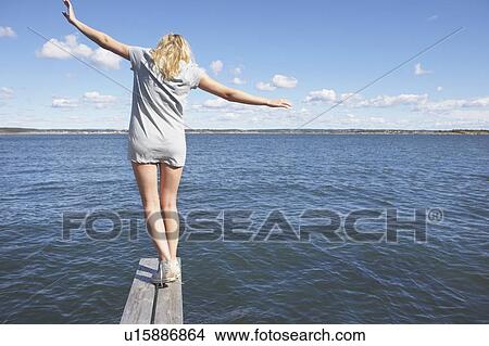 Picture - Young woman on diving platform.. Fotosearch