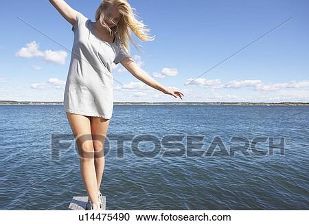 Stock Image - Young woman on diving platform.. Fotosearch