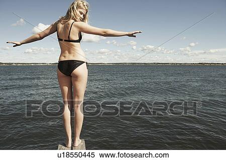 Stock Photography - Young woman on diving platform.. Fotosearch