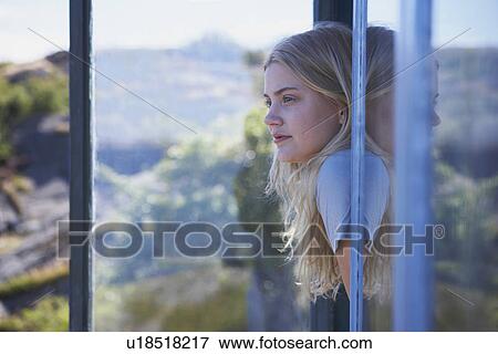 Young Woman Sitting in Long grass. View Large Photo Image Stock Photo - Young Woman Sitting in Long grass.. Fotosearch