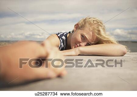 Young Woman sitting outdoors. View Large Photo Image Picture - Young Woman sitting outdoors.. Fotosearch