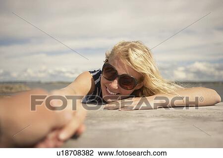 Young Woman sitting outdoors. View Large Photo Image Stock Image - Young Woman sitting outdoors.. Fotosearch