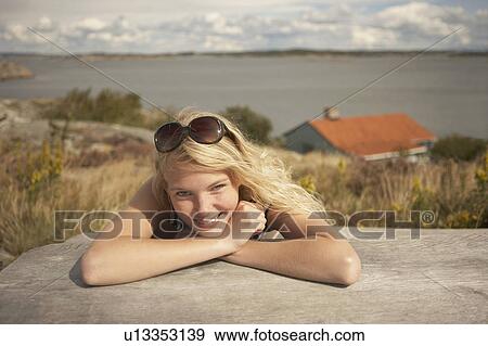 Young Woman sitting outdoors. View Large Photo Image Stock Photo - Young Woman sitting outdoors.. Fotosearch