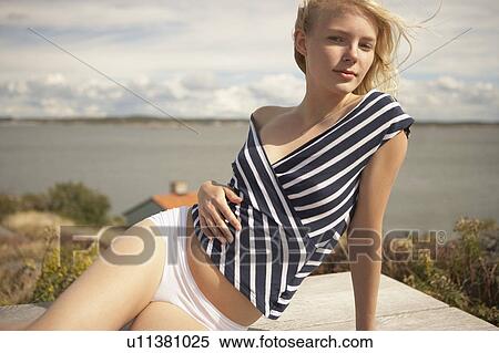 Young Woman sitting outdoors. View Large Photo Image Stock Photography - Young Woman sitting outdoors.. Fotosearch