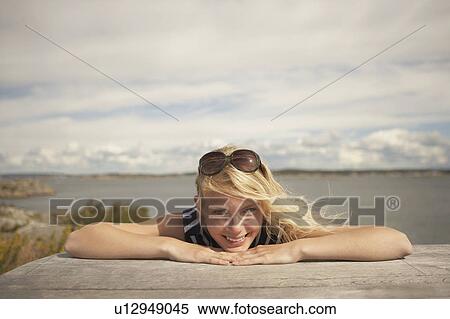 Young Woman sitting outdoors. View Large Photo Image Stock Photography - Young Woman sitting outdoors.. Fotosearch