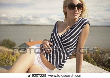 Young Woman sitting outdoors. View Large Photo Image Stock Photography - Young Woman sitting outdoors.. Fotosearch
