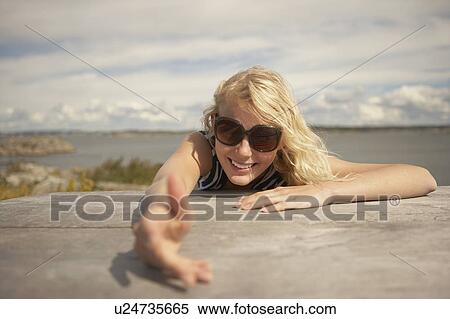 Stock Photography - Young Woman sitting outdoors.. Fotosearch